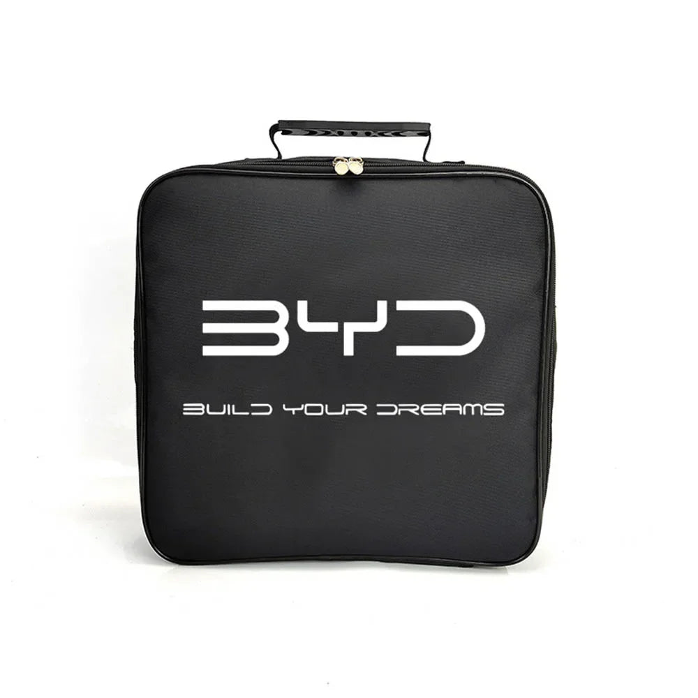 BYD electric vehicle charging cable storage bag on car boot carpet, part of a new EV owner accessory checklist