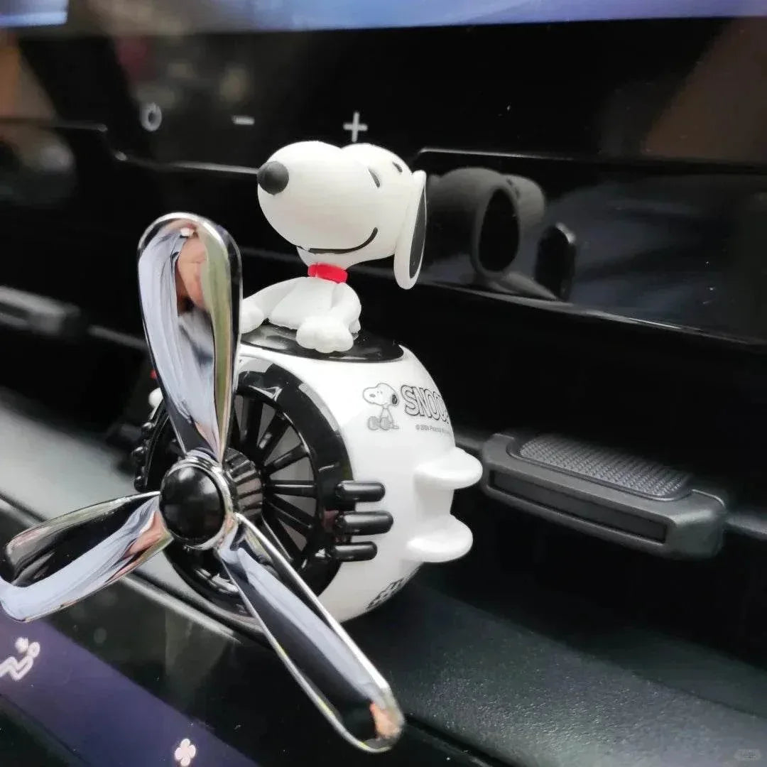 Novelty Snoopy car air freshener clipped to an air vent