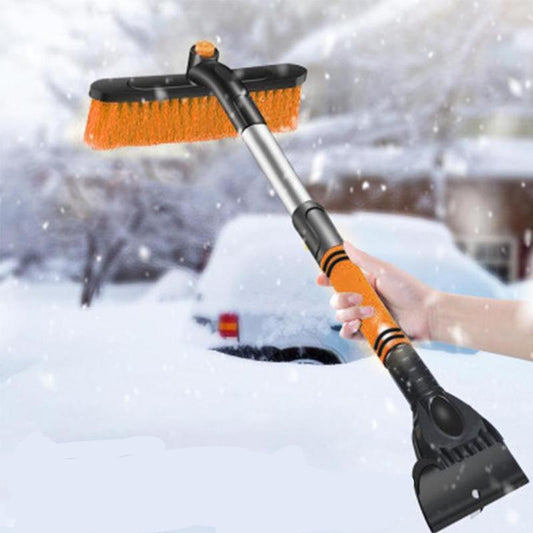 Snow, ice, and frost removal tool with a brush and scraper in front of a snow-covered car.